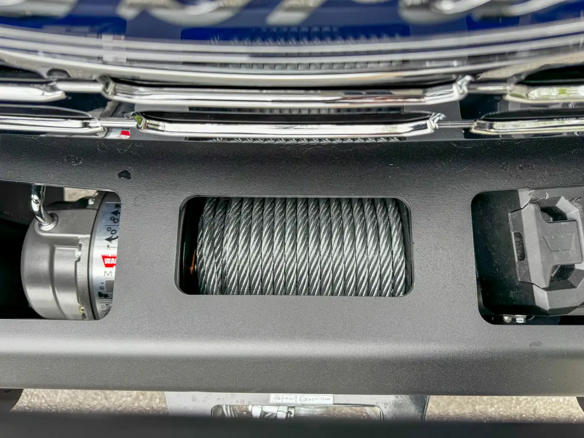 Driver-side interior wide view with steering wheel, dashboard, and center console.